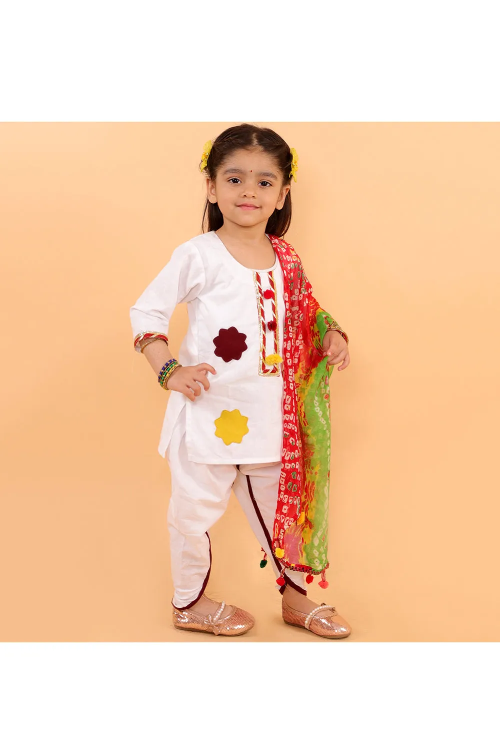 White kurta with colorful patches and dhoti with bandhani dupatta