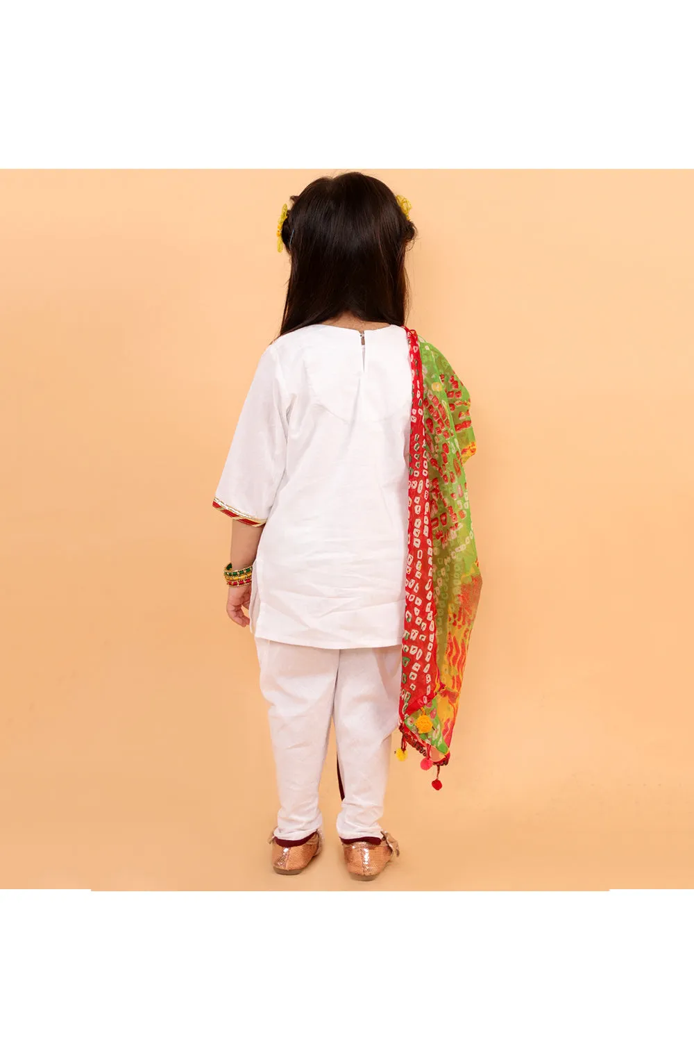 White kurta with colorful patches and dhoti with bandhani dupatta